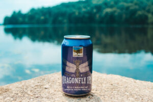 Dragonfly IPA next to lake
